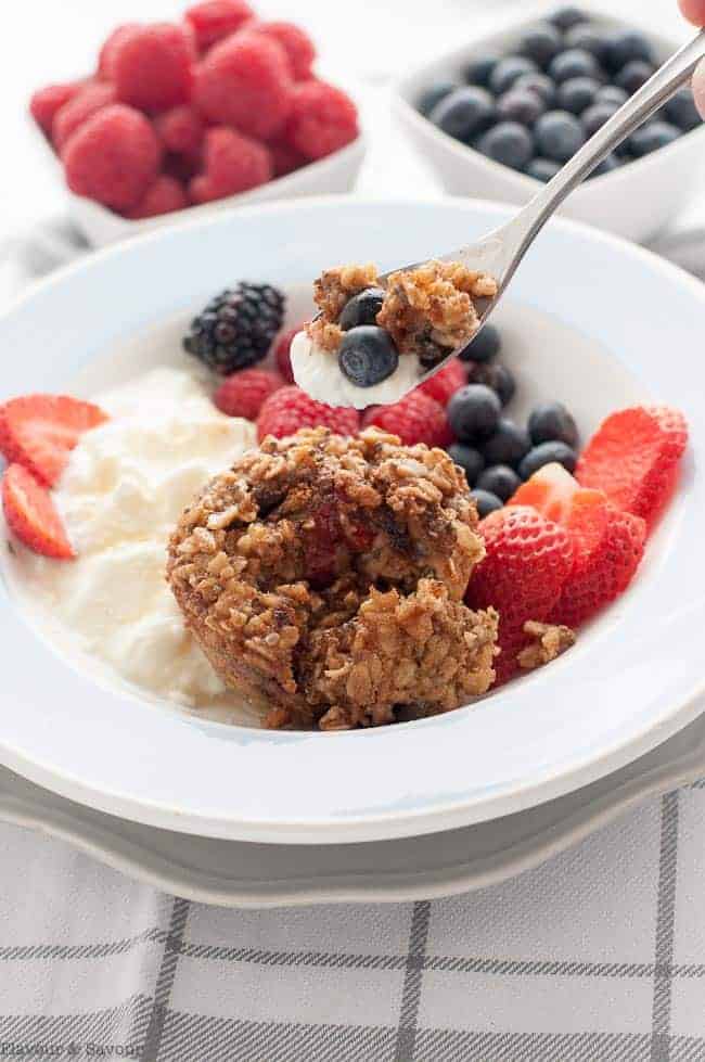 Serving suggestion:: Mixed Berry Baked Oatmeal Cups in a bowl with yogurt or kefir and fresh berries.