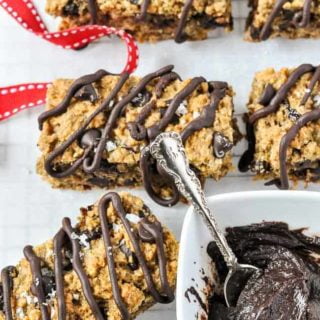 Close up view of Chocolate Cherry Chia Bars with a pot of melted chocolate