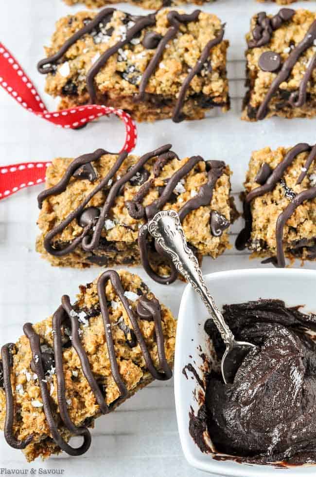 Close up view of Chocolate Cherry Chia Bars with a pot of melted chocolate