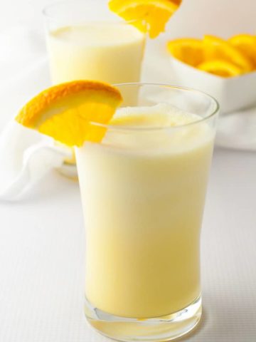 Orange Collage Creamsicle Shake with orange wedge garnish