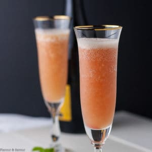 Two glasses of Rhubarb Bellini with Prosecco in champagne flutes