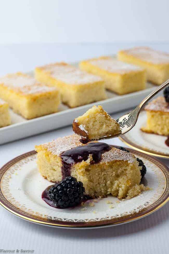 a forkful of Flourless Lemon Almond Ricotta Cake with Blackberry Coulis