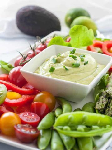 Mayo-Free Avocado Green Goddess Dressing and Dip surrounded by fresh vegetables.