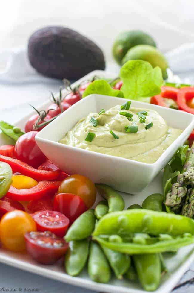 Mayo-Free Avocado Green Goddess Dressing and Dip surrounded by fresh vegetables.