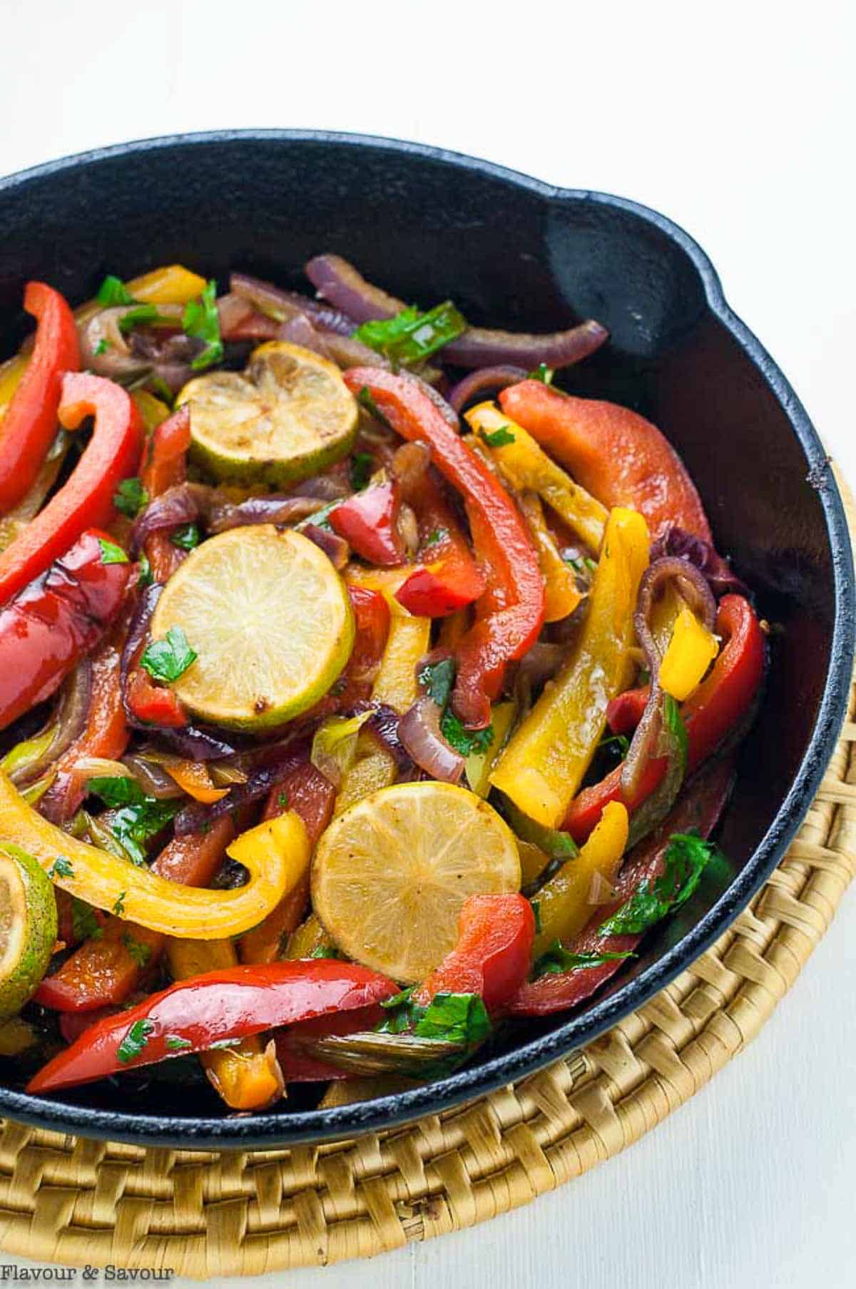 Sautéed peppers and onions in a cast iron pan for Fajita Salad