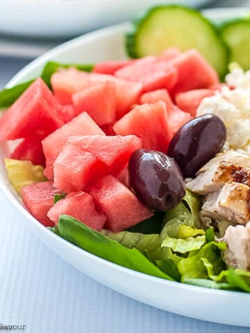 A bowl of Skinny Greek Chicken Watermelon Salad with feta cheese.