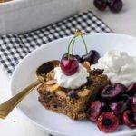 Chocolate Espresso Baked Oatmeal with yogurt and cherries in a bowl
