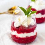 Easy Raspberry Rhubarb Fool layered in a dessert glass with mint.