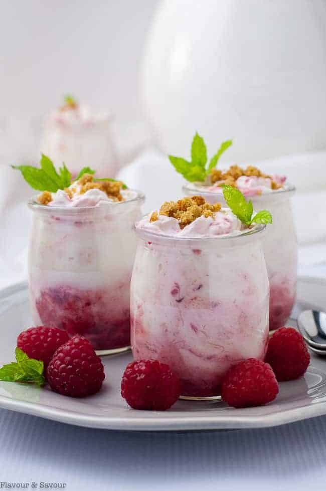 Easy Raspberry Rhubarb Fool in mini dessert glasses garnished with mint and fresh raspberries