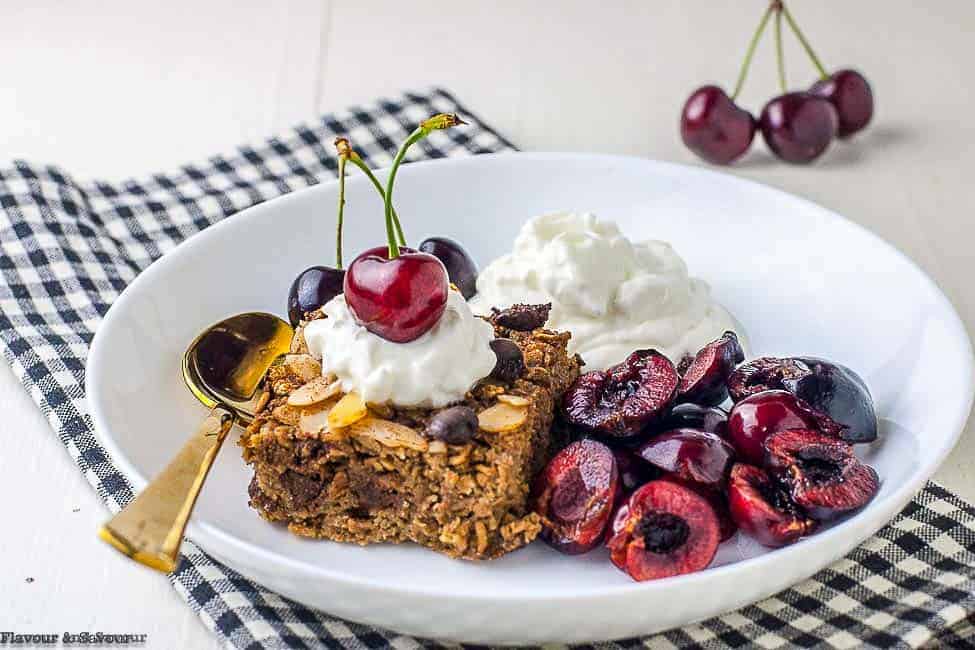 Chocolate Espresso Baked Oatmeal in a white bowl with cherries