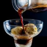 Pouring espresso over ice cream to make an affogato coffee dessert.