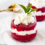 a glass of layered raspberry rhubarb fool