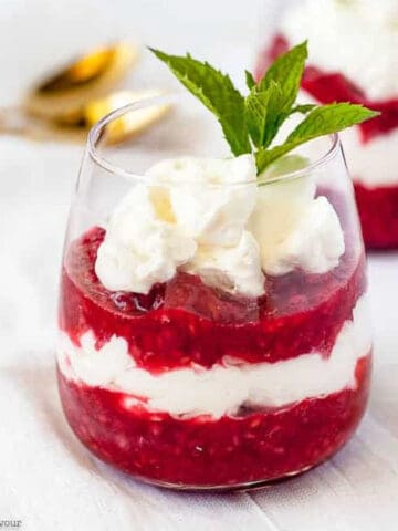 a glass of layered raspberry rhubarb fool