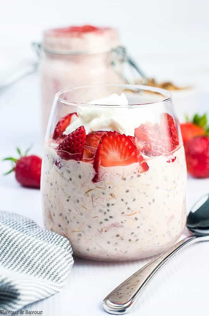 Strawberry Rhubarb Overnight Oats in a dessert glass with sliced strawberries