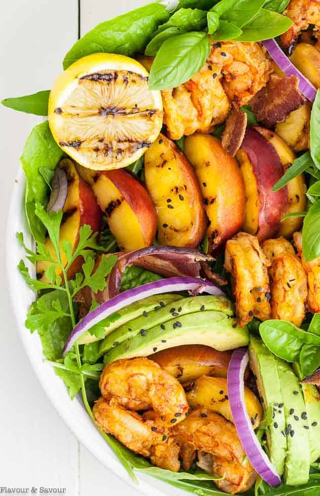Close up view of Avocado Grilled Peach and Chipotle Shrimp Salad with Bacon