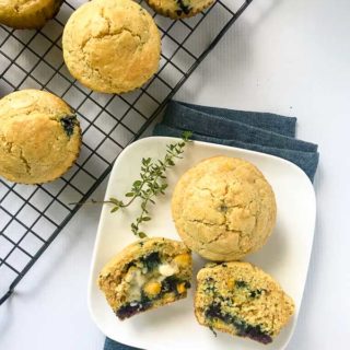 Gluten-free Blueberry Buttermilk Cornbread Muffins with melting butter