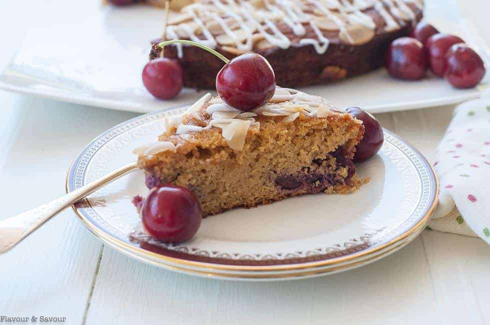 Close up view of a slice of Flourless Cherry Almond Ricotta Cake