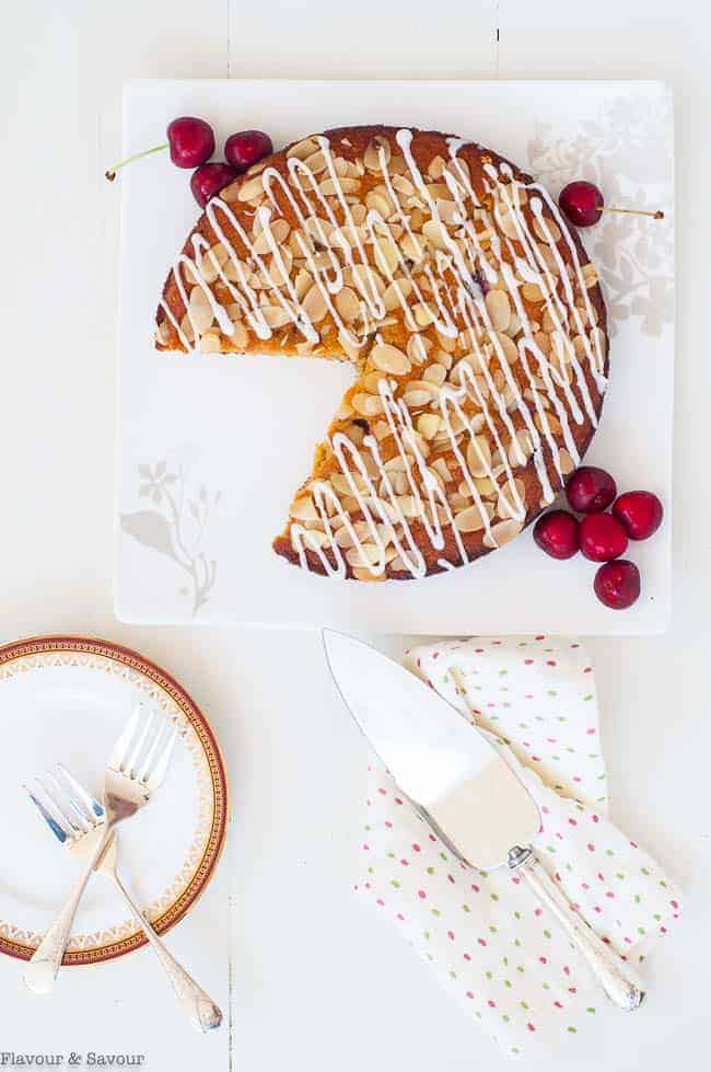 Flourless Cherry Almond Ricotta Cake  on a square white plate, overhead view