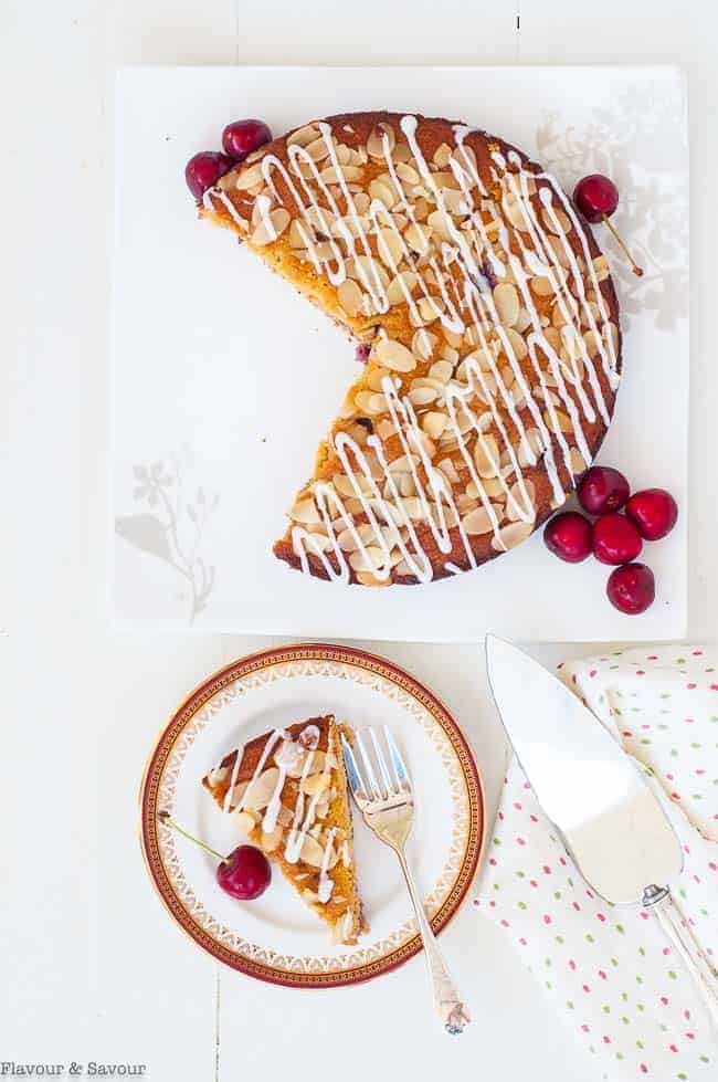 Flourless Cherry Almond Ricotta Cake overhead view of a cake and a slice