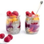 Two mini glasses of chia seed pudding with raspberries