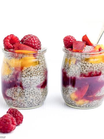 Two mini glasses of chia seed pudding with raspberries