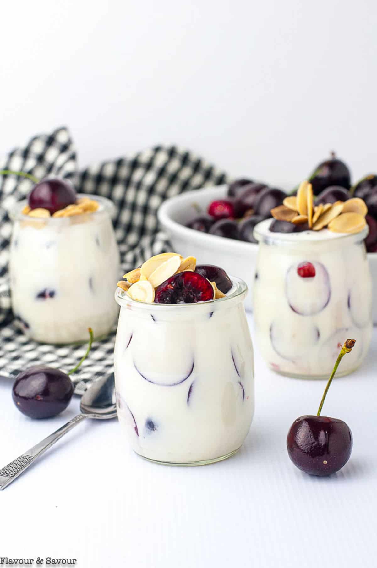 3 mini jars of creamy cherry ricotta parfait with fresh cherries