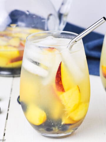 a glass of peach sangria