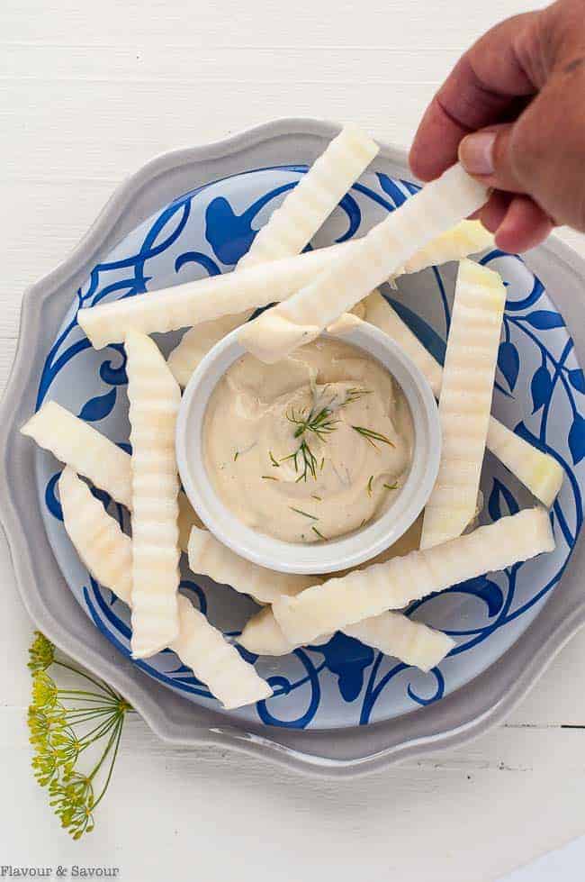 Dipping Crispy Raw Kohlrabi Sticks into Dijon Dilly Dip