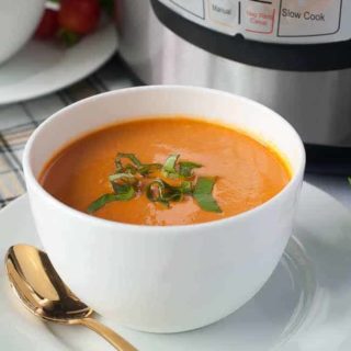 Wholesome Instant Pot Creamy Tomato Soup in bowls with Instant Pot in the background.