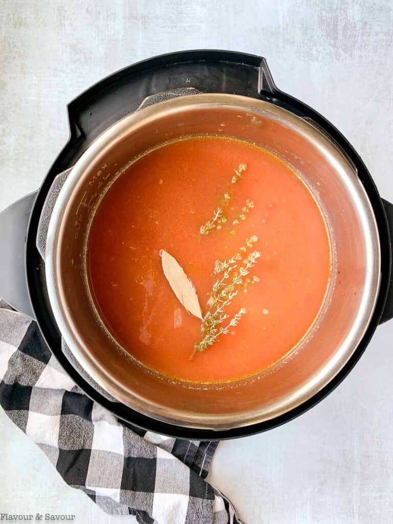 tomatoes, broth and herbs in instant pot