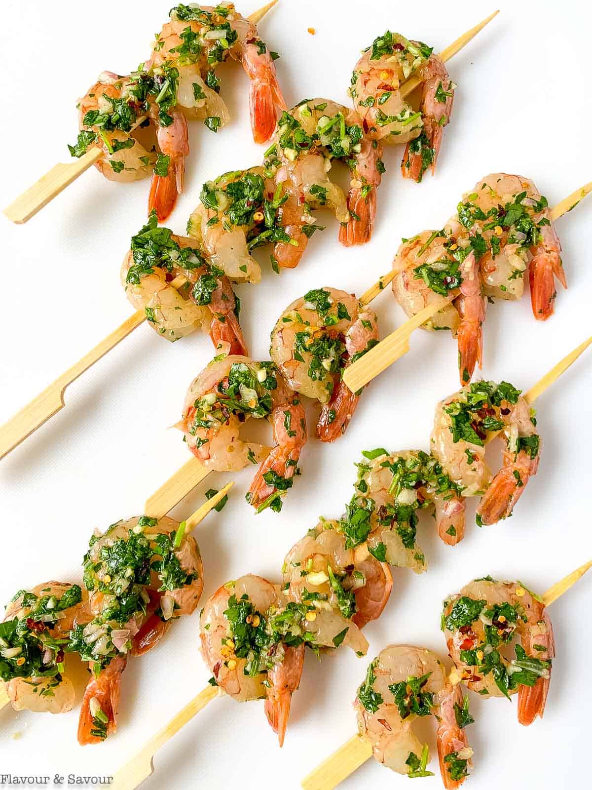 Chimichurri shrimp on skewers ready to grill.