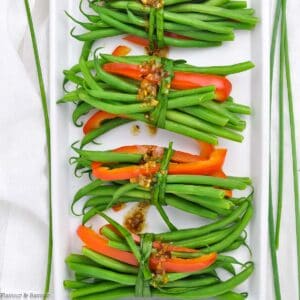 overhead view of vegetarian green bean bundles with garlic butter