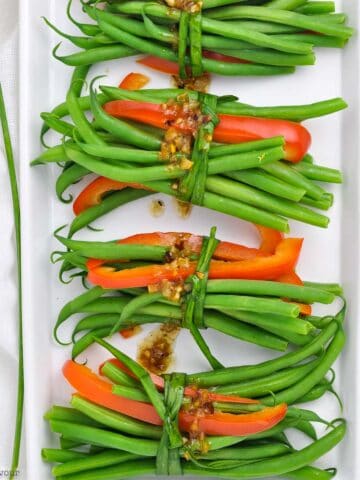 overhead view of vegetarian green bean bundles with garlic butter