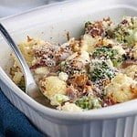 Cheesy Bacon Broccoli Cauliflower Casserole in a white serving dish