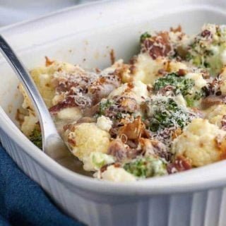 Cheesy Bacon Broccoli Cauliflower Casserole in a white serving dish