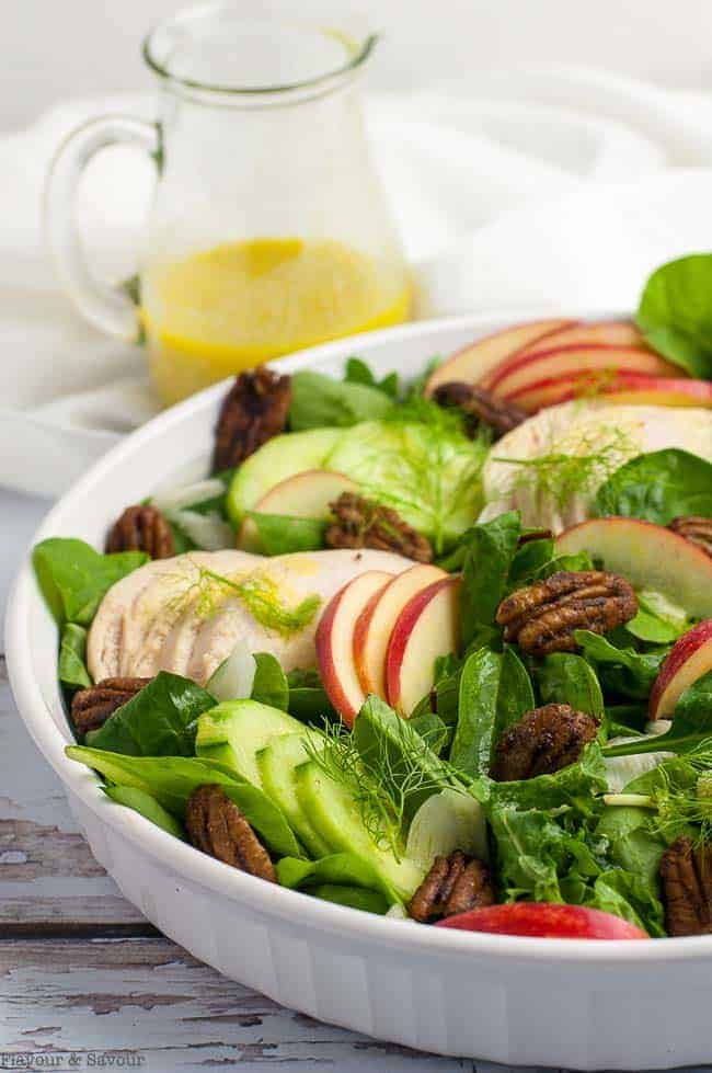 Fennel Apple Chicken Salad with a a jug of dressing