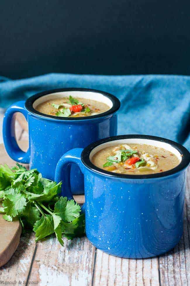 Two blue mugs of Slow Cooker Moroccan Harissa Cauliflower Soup