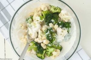 Combining cheese mixture with veggies for Cheesy Bacon Broccoli Cauliflower Casserole