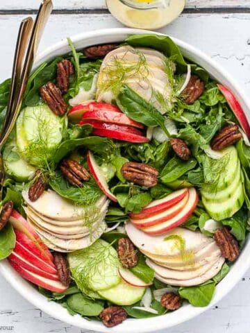 Fennel apple chicken salad in a shallow bowl, overhead view.