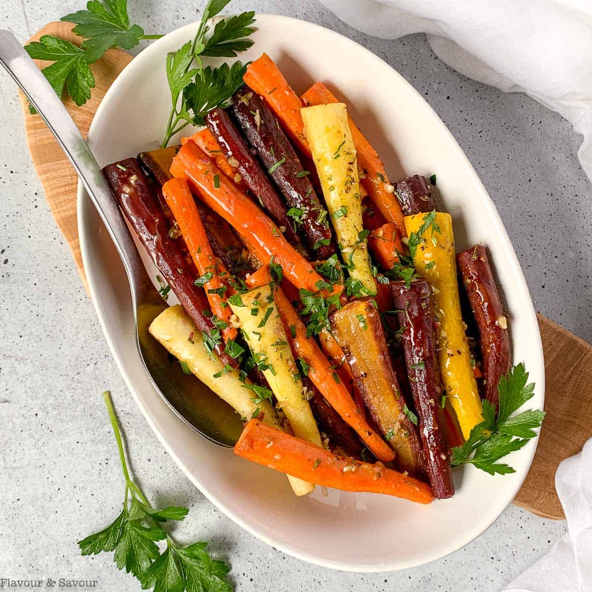 A bowl of roasted rainbow carrots with feta and pistachios.