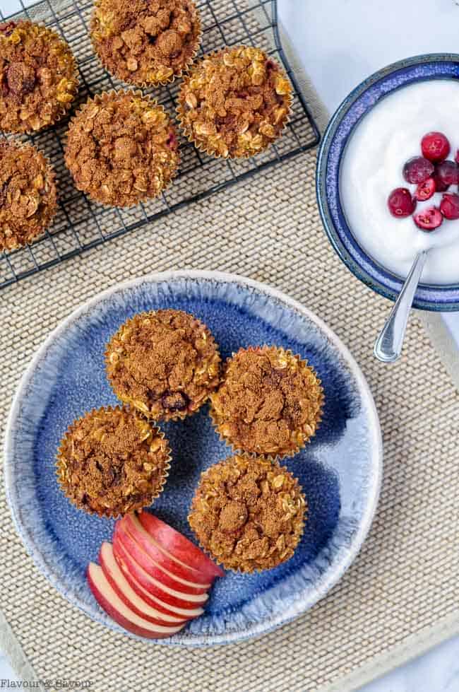 Overhead view of baked oatmeal cups and yogurt.