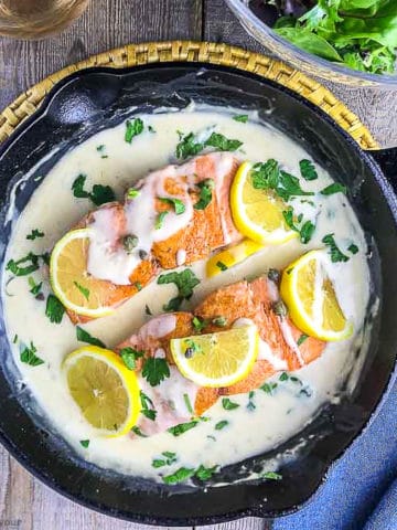 Creamy Lemon Salmon Piccata in a cast iron skillet