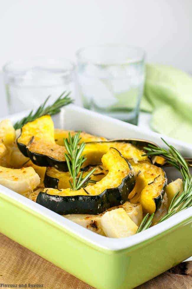 Garlic Parmesan Roasted Acorn Squash in serving dish with fresh rosemary
