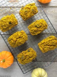 MIni Gluten-Free Pumpkin Loaves on cooling rack with pumpkins
