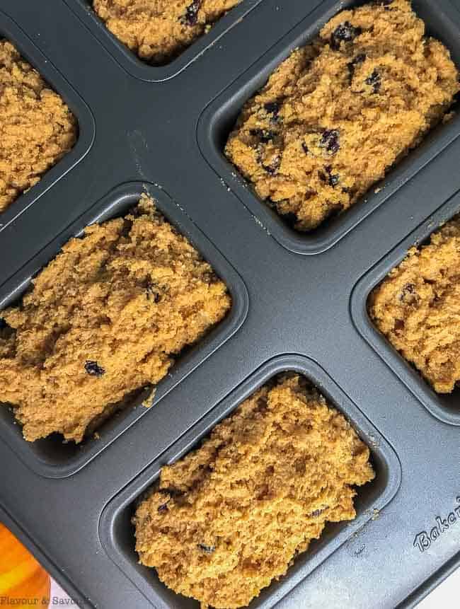 Mini pumpkin loaves in an 8-cavity mini muffin pan.