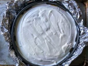 Spreading Sour Cream topping on Low-Carb Gluten-Free Pumpkin Cheesecake