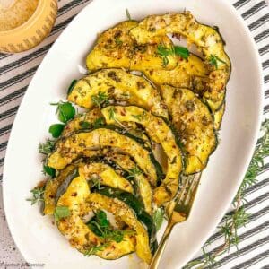 A platter filled with garlic parmesan crusted acorn squash slices.