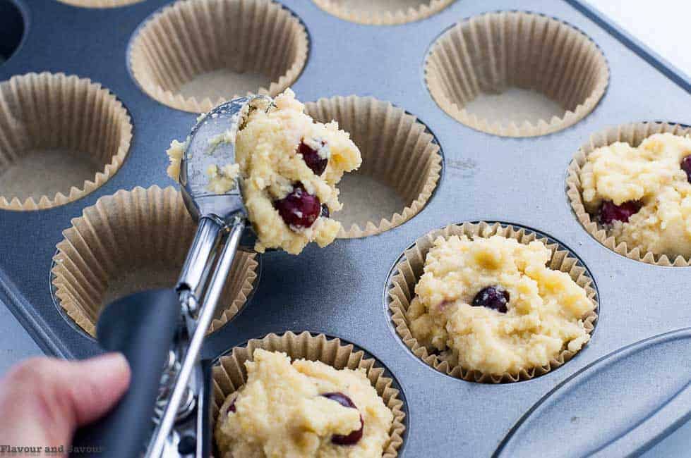 Filling muffins cups to make Gluten-Free Cranberry Lemon Muffins