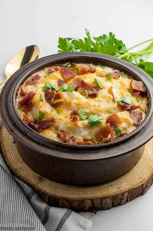 Instant Pot Mashed Cauliflower with Bacon and Cheese in a stoneware bowl