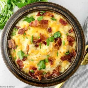 a bowl of instant pot mashed cauliflower with bacon and cheese